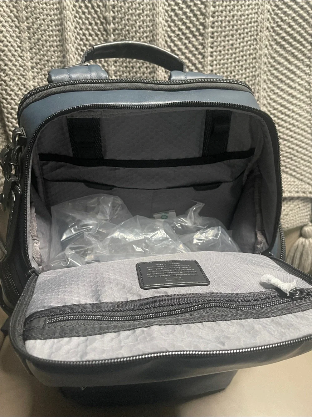Tumi Men's Blue Travel Backpack with Front Zip Pocket.  It has never been used